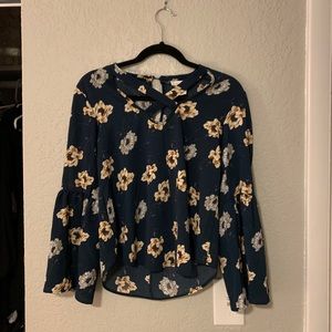 Blue flower top, cross in front, arms are cut out
